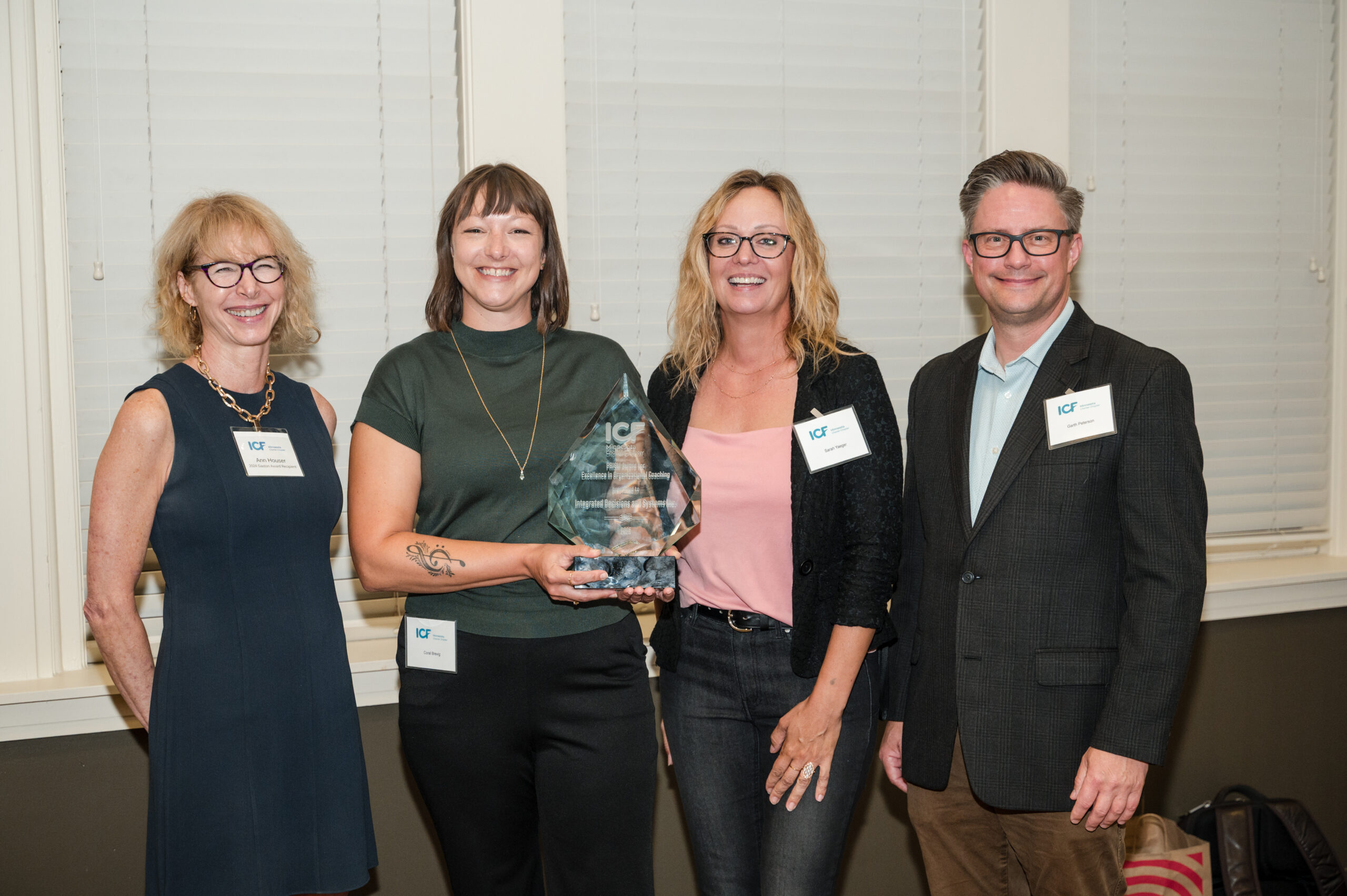 Accepting the 2025 ICF Minnesota PRISM Award for IDeaS Revenue Solutions, joined by Bailey Group CEO Ann Houser